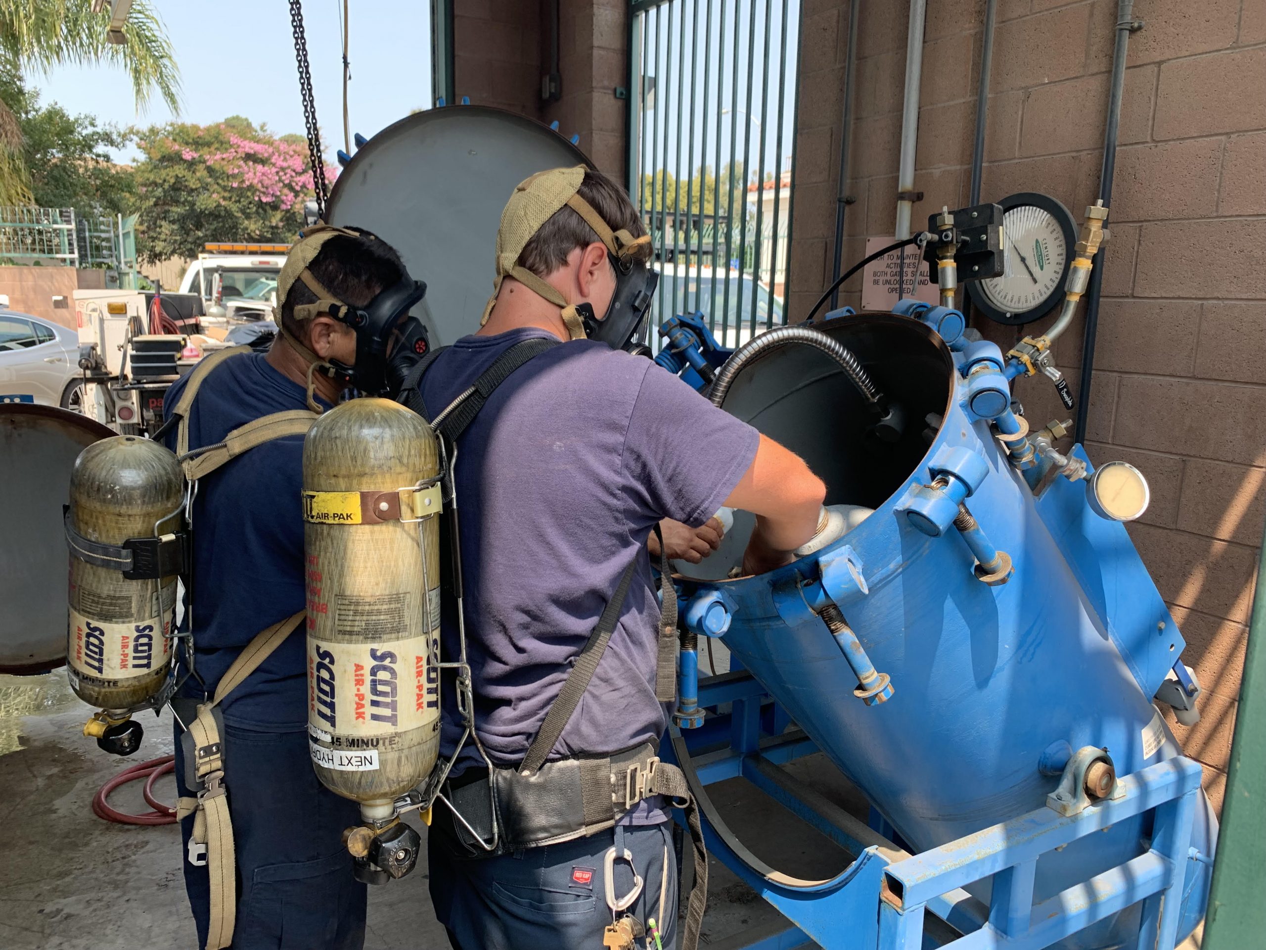 ChlorTainer chemical container. Image of a chlorine technician switching out a ton cylinder of chlorine