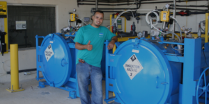 ChlorTainer operator standing next to chlorine containment system. 